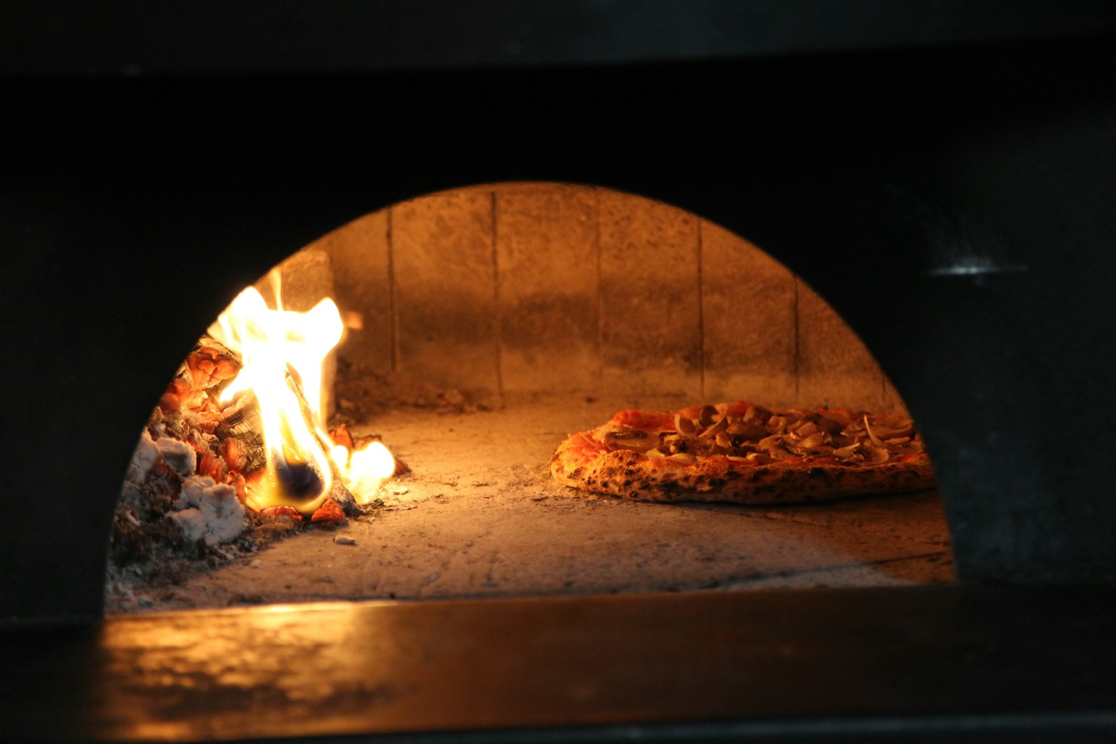 Nahaufnahme einer Pizza im heißen Pizzaofen